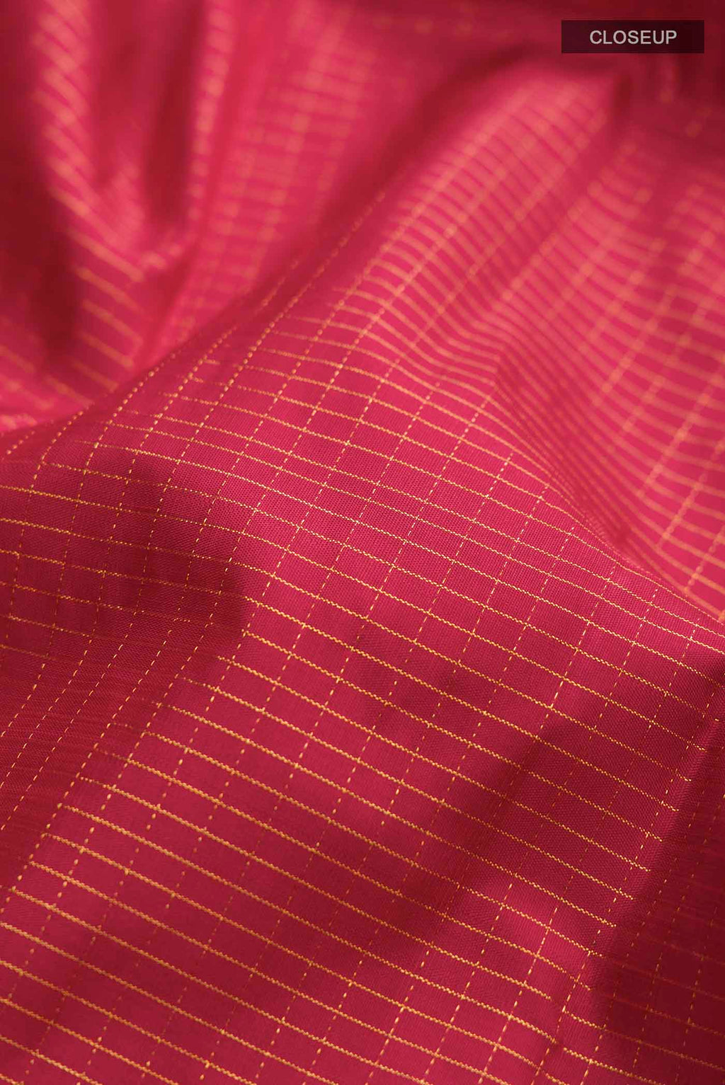 Close up of Maroon Kanchipuram Silk Saree with Checked design on the body and Zari Border displaying folds