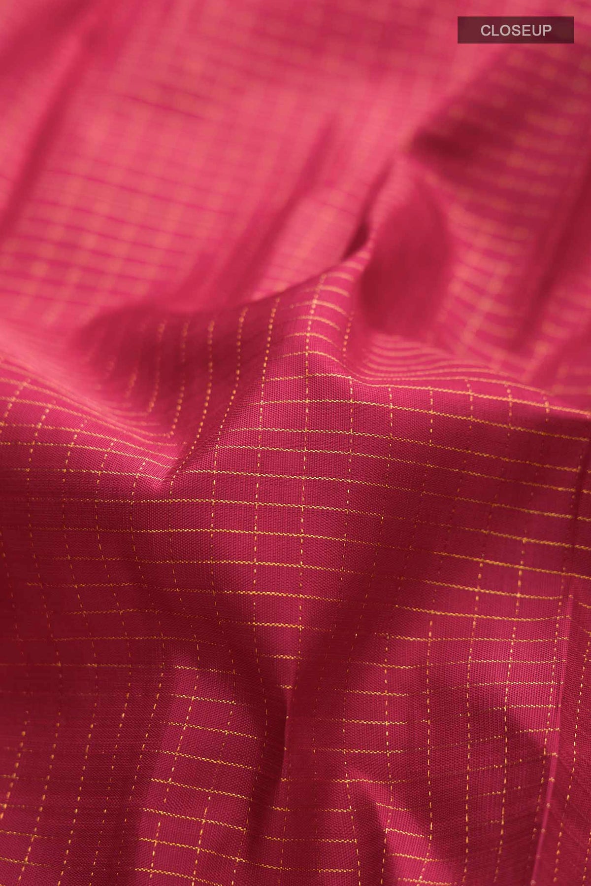 Close up of Maroon Kanchipuram Silk Saree with Stripes on the body and Zari Border displaying folds