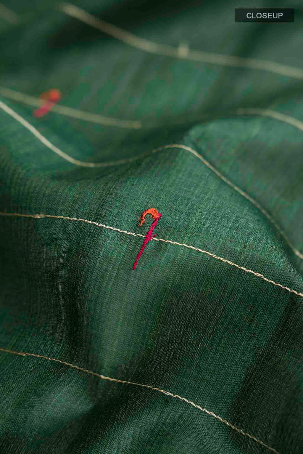 Close up of Green Tussar Silk Saree with Stripes on the body and Zari Border displaying folds