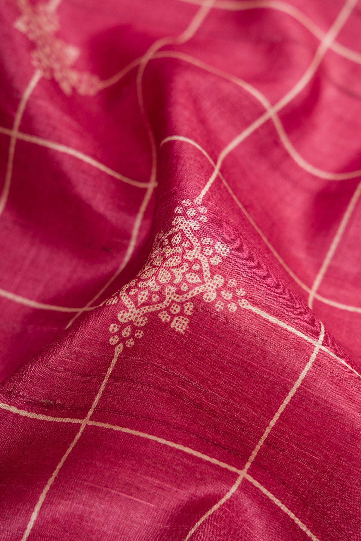Close up of Pink Dual Tone Tussar Silk Saree with Checked design on the body and Zari Border.  displaying folds