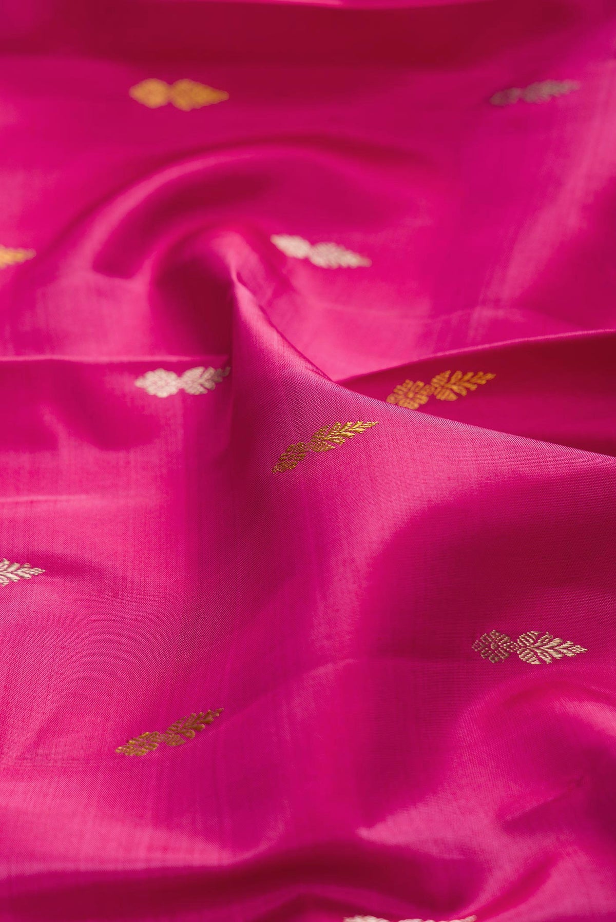 Close up of Pink Dual Tone Kanchipuram Silk Saree with Zari Butta on the body and Zari Border displaying folds