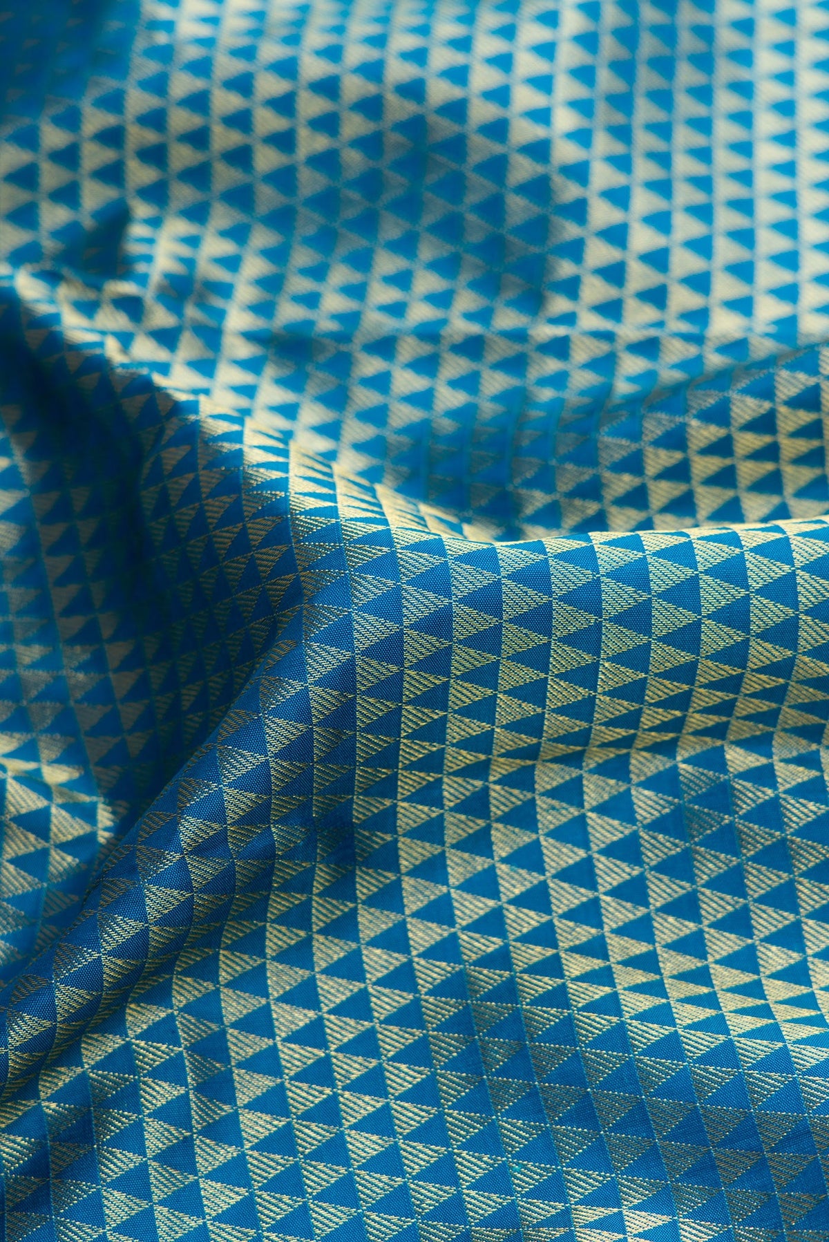 Close up of Peacock Blue Dual Tone Kanjivaram Silk Saree with Zari Brocade on the body and Zari Border.  displaying folds