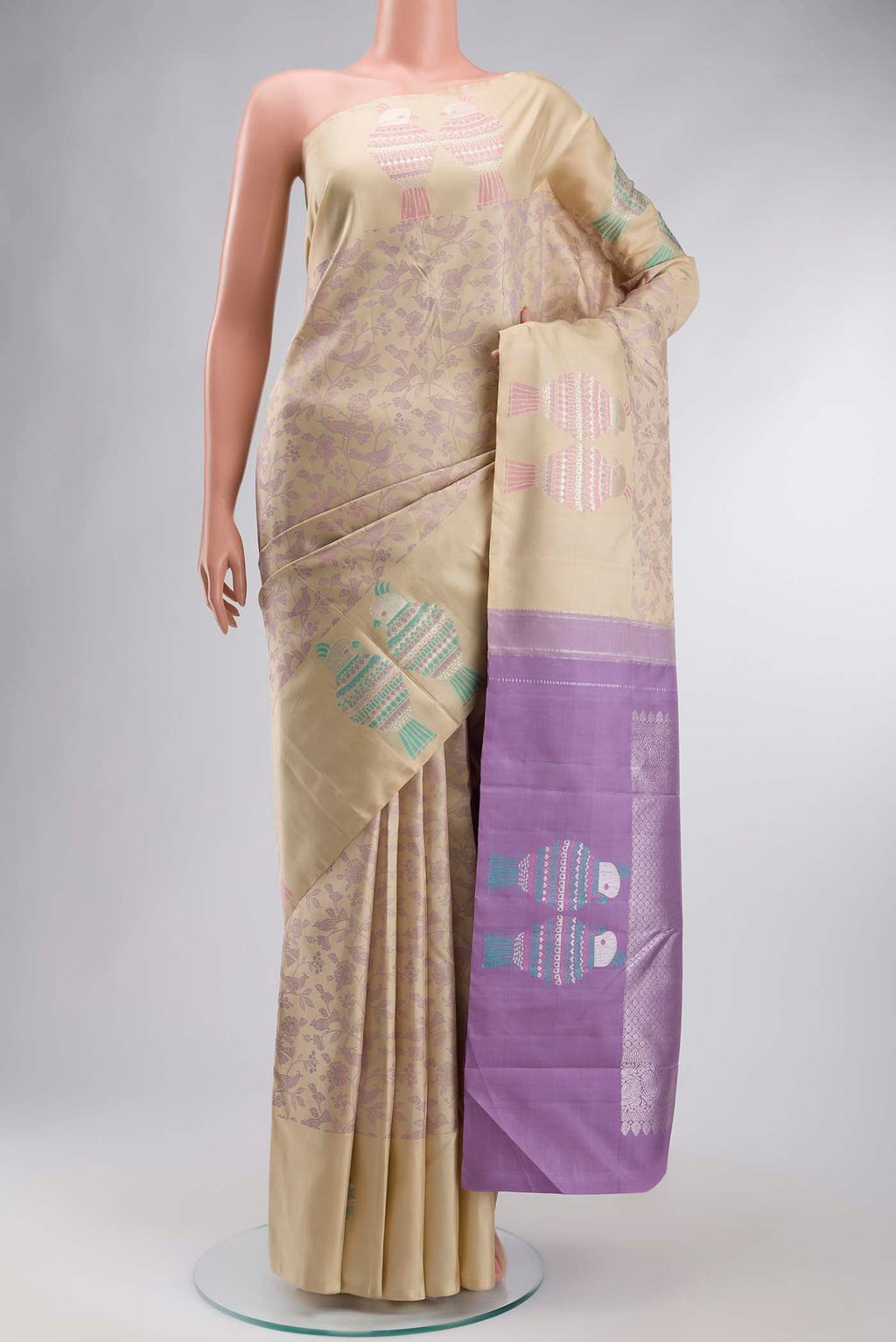 Beige Kanchipuram Silk Saree with Jacquard design on the body and Zari Border displayed on a mannequin