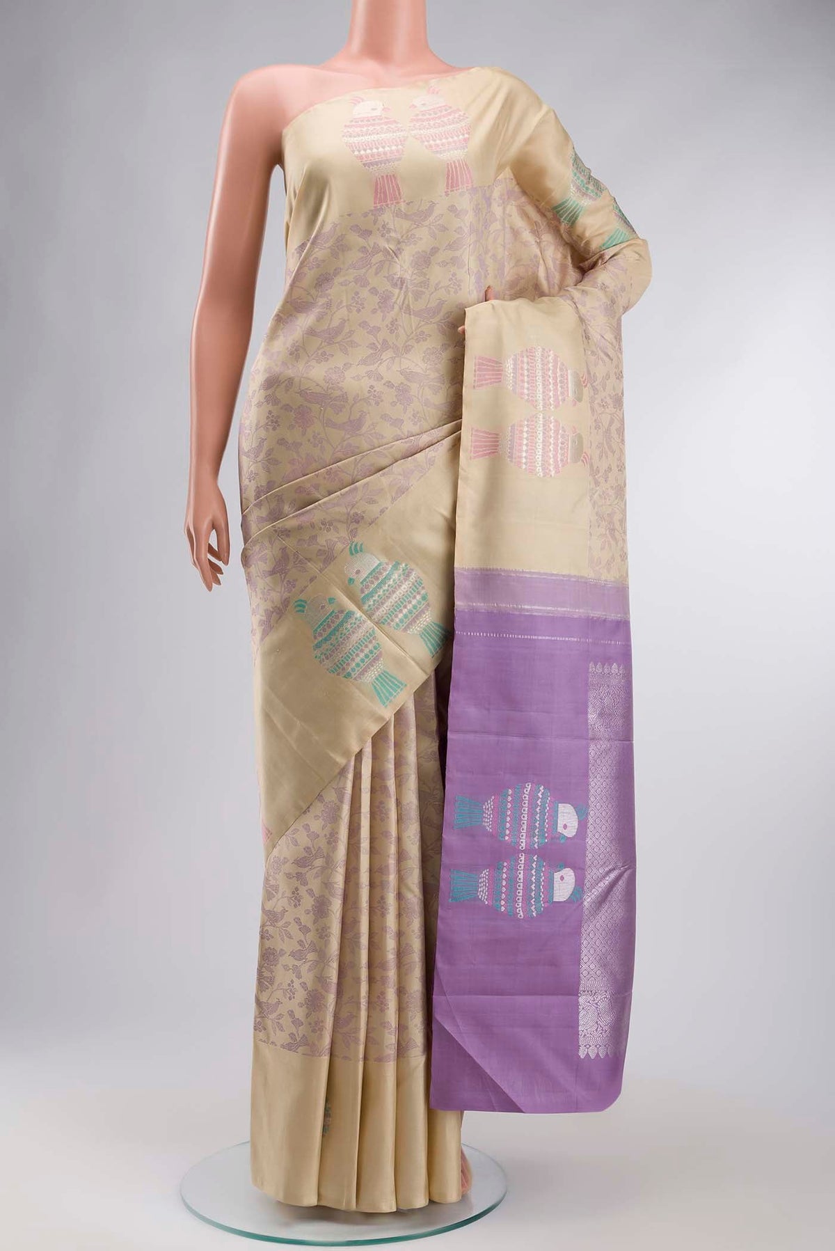 Beige Kanchipuram Silk Saree with Jacquard design on the body and Zari Border displayed on a mannequin