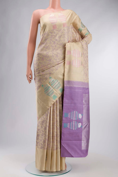Beige Kanchipuram Silk Saree with Jacquard design on the body and Zari Border displayed on a mannequin