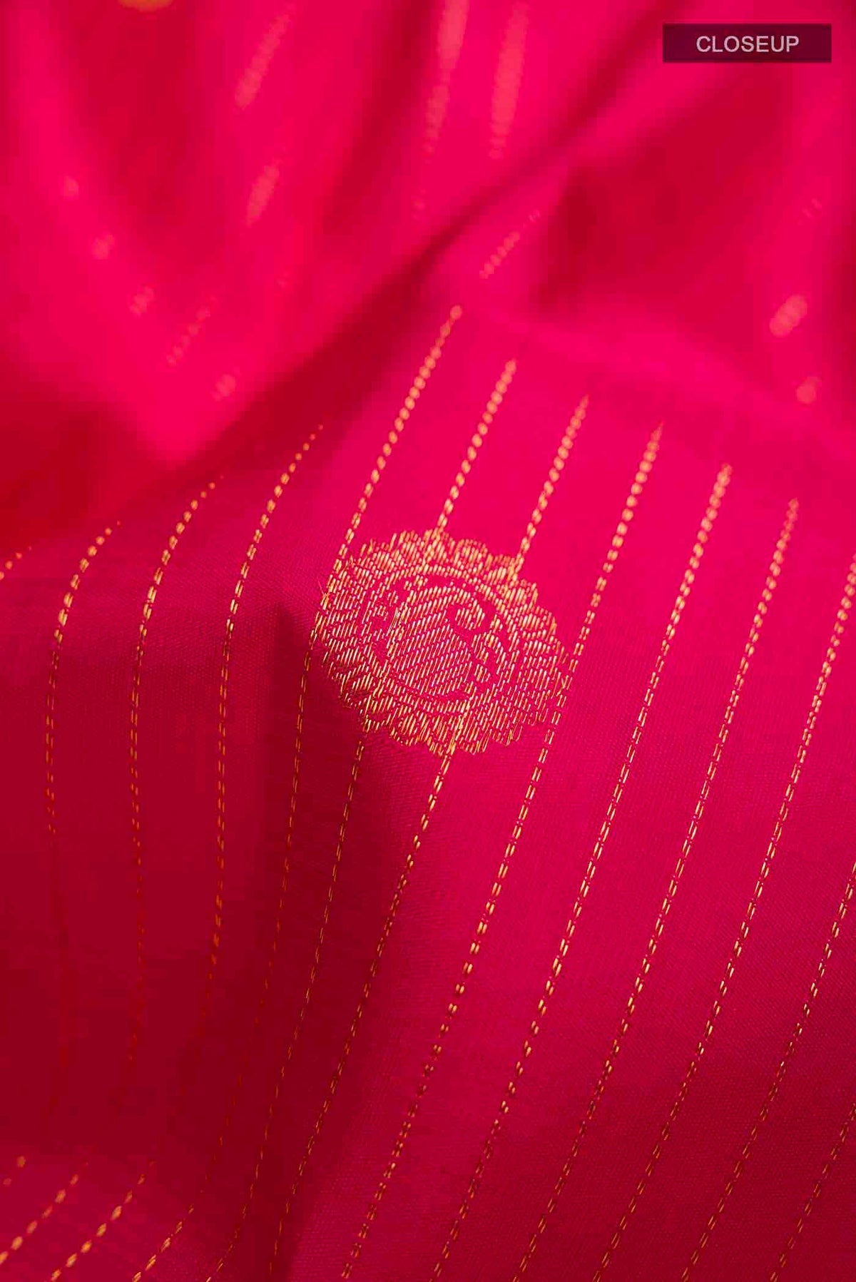 Close up of Pink Kanchipuram Silk Saree with Stripes on the body and Zari Border displaying folds