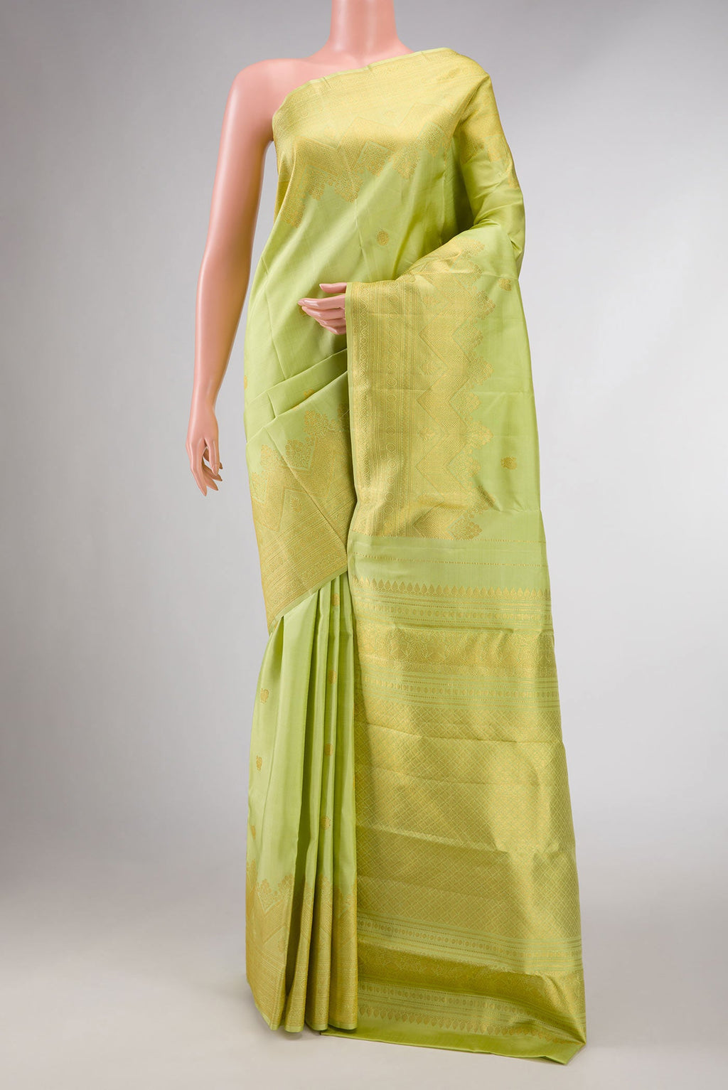 Green Dual Tone Kanchipuram Silk Saree with Zari Butta on the body and Zari Border displayed on a mannequin