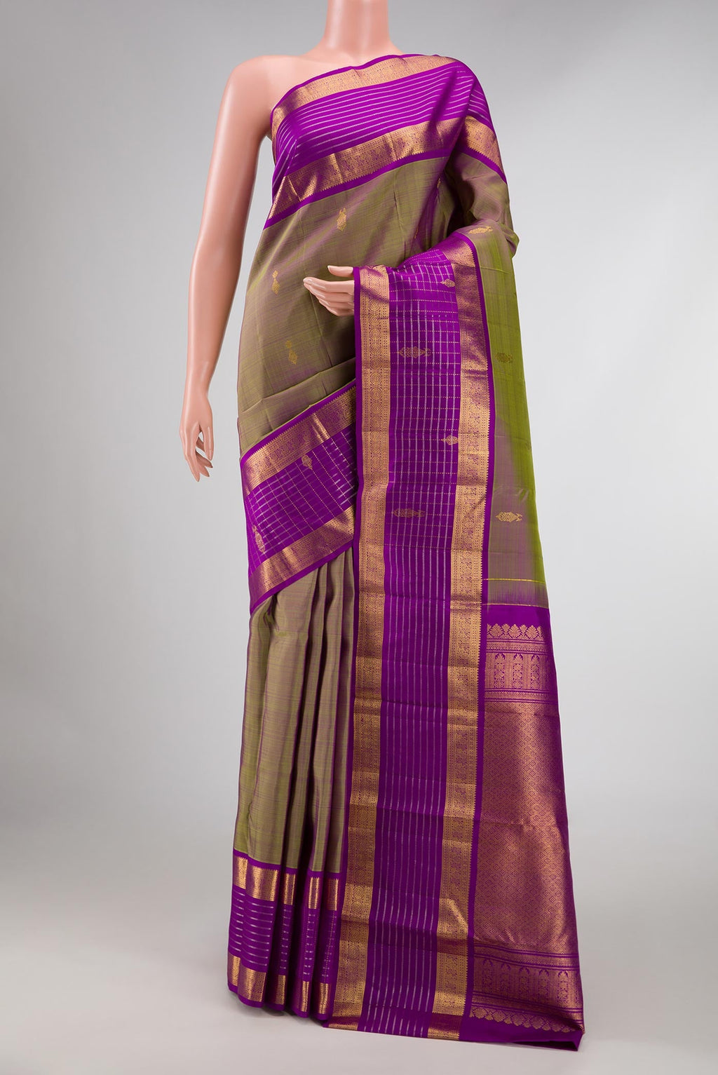 Green with Purple Color Kanchipuram Silk Saree with Zari Butta on the body and Zari Border displayed on a mannequin