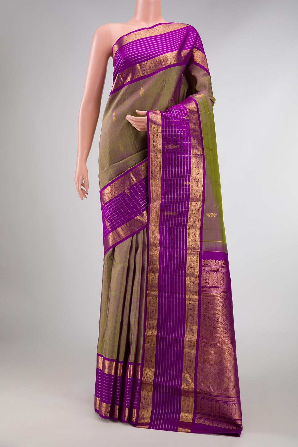 Green with Purple Color Kanchipuram Silk Saree with Zari Butta on the body and Zari Border displayed on a mannequin