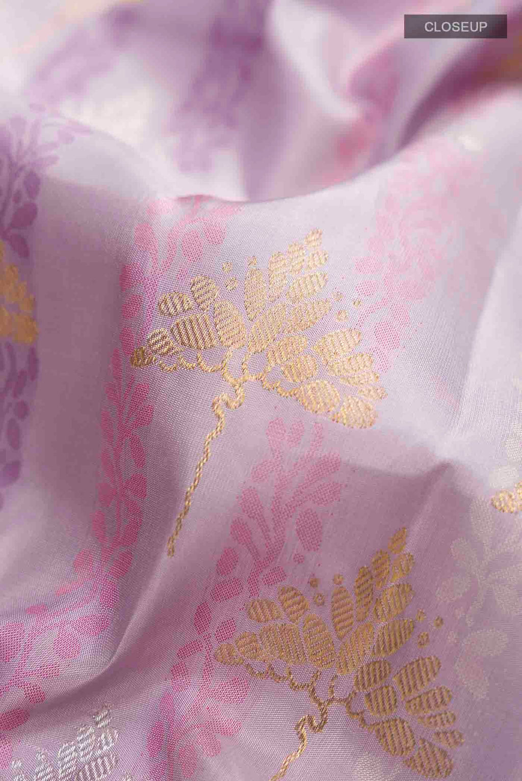 Close up of Lavender Kanchipuram Silk Saree with Jacquard With Zari Butta on the body and Zari Border displaying folds