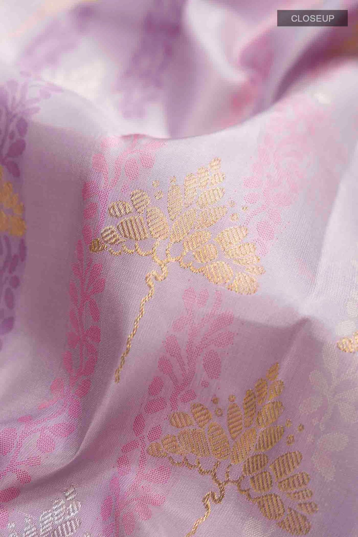 Close up of Lavender Kanchipuram Silk Saree with Jacquard With Zari Butta on the body and Zari Border displaying folds
