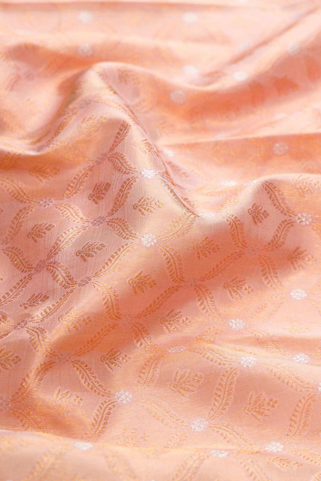 Close up of Rose Gold Dual Tone Kanchipuram Silk Saree with Zari Brocade on the body and Zari Border displaying folds