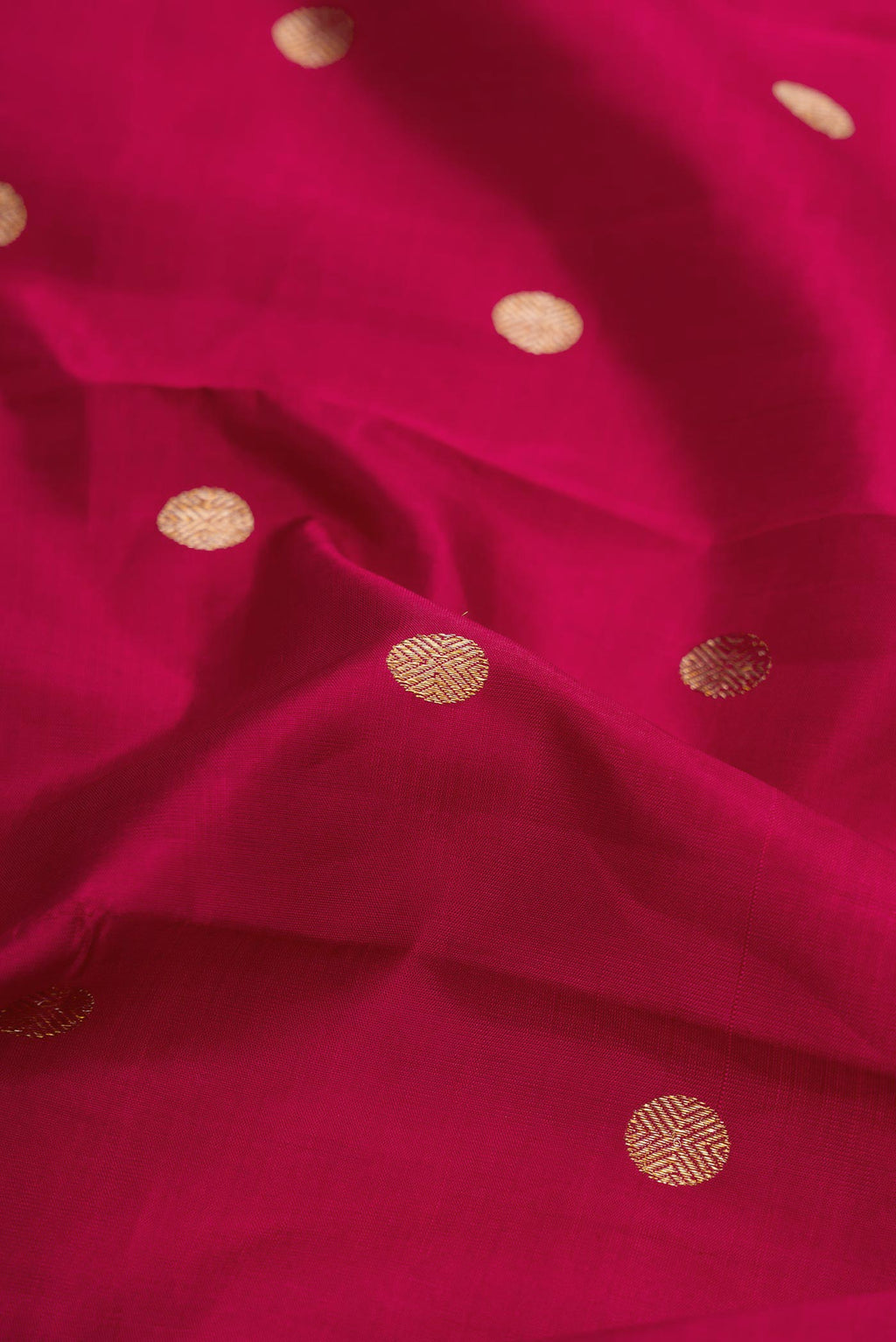 Close up of Maroon Dual Tone Kanchipuram Silk Saree with Zari Butta on the body and Zari Border displaying folds