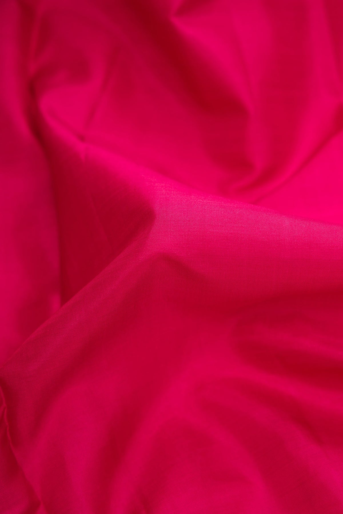 Close up of Pure Silk Pure Zari Maroon Dual Tone Kanjivaram Saree with Plain Body and Zari Border.  displaying folds