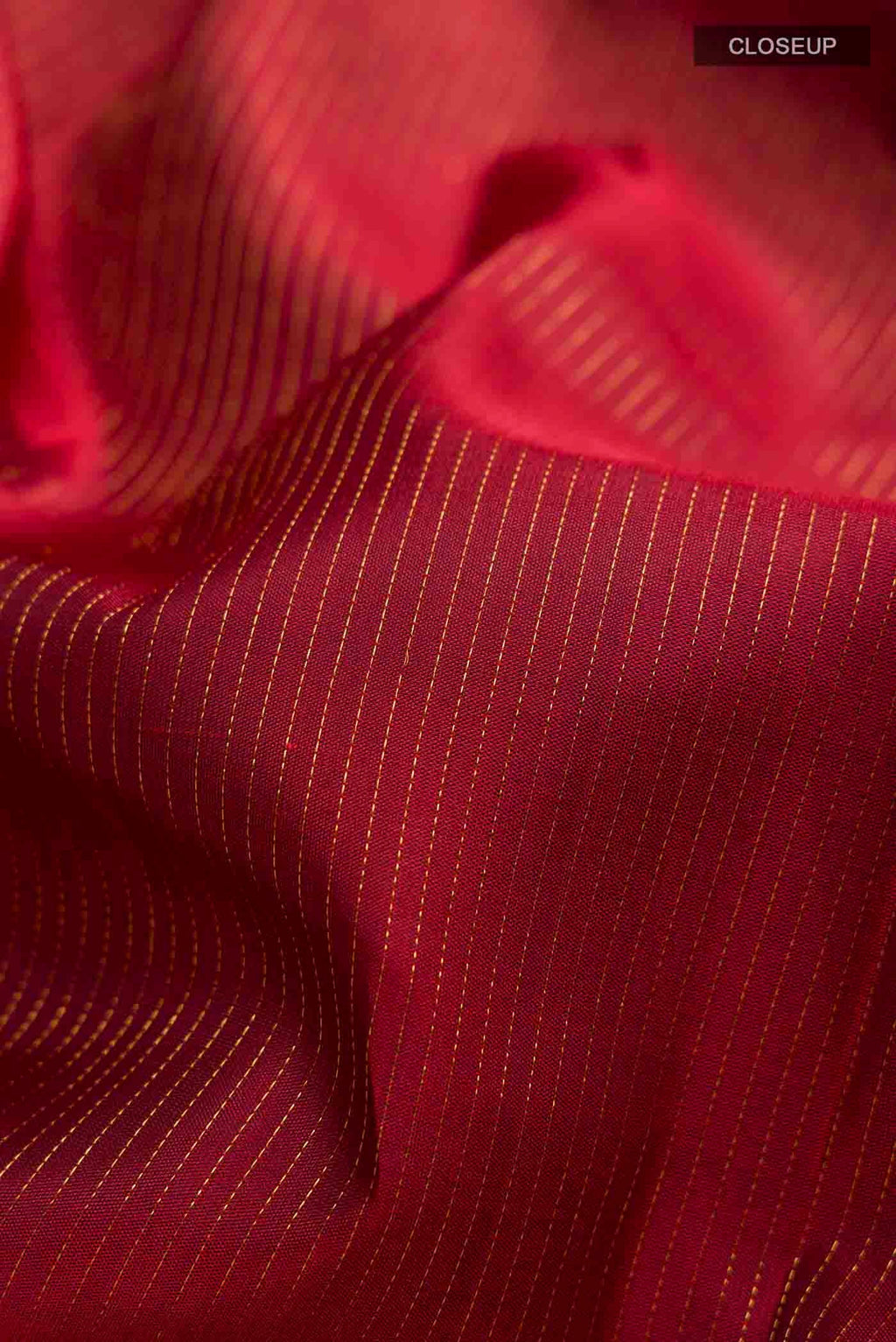 Close up of Maroon Kanchipuram Silk Saree with Stripes on the body and Zari Border displaying folds