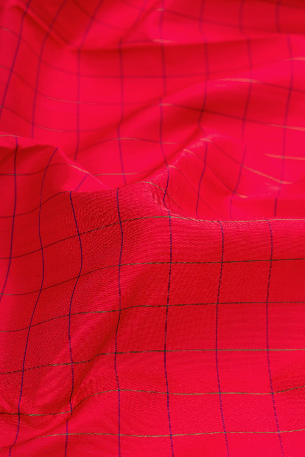 Close up of Red Dual Tone Kanchipuram Silk Saree with Checked design on the body and Zari Border.  displaying folds
