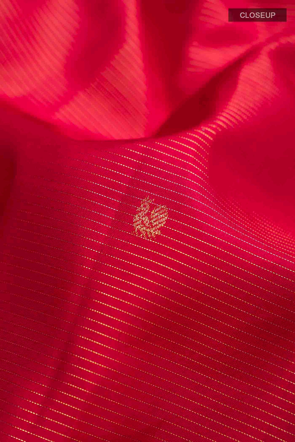 Close up of Maroon Kanchipuram Silk Saree with Stripes on the body and Zari Border displaying folds