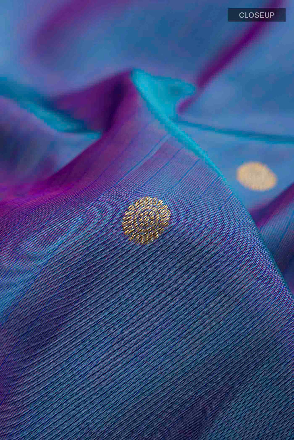 Close up of Blue Kanchipuram Silk Saree with Zari Butta on the body and Zari Border displaying folds