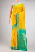 Yellow Dual Tone Kanjivaram Silk Saree with Zari Butta on the body and Zari Border.  displayed on a mannequin