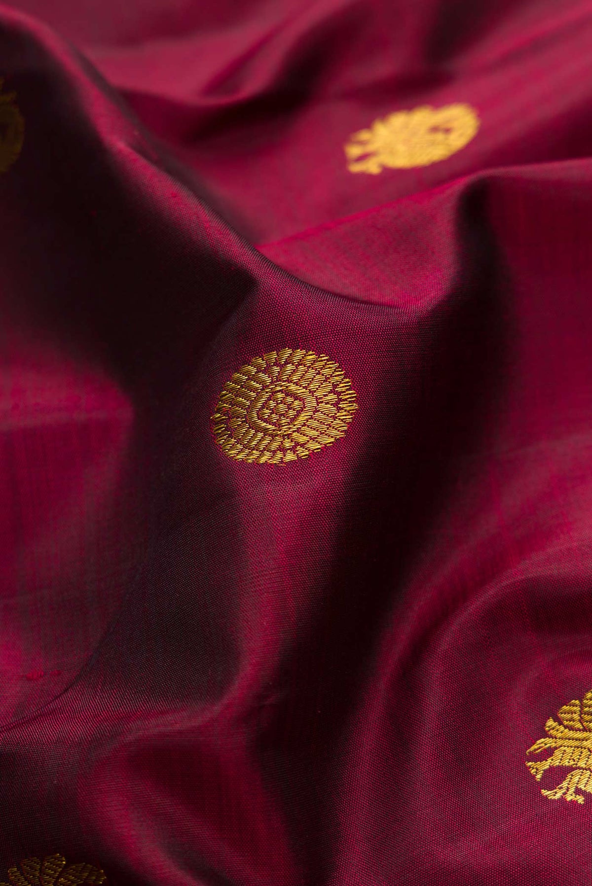 Close up of Maroon Dual Tone Kanchipuram Silk Saree with Zari Brocade on the body and Zari Border displaying folds