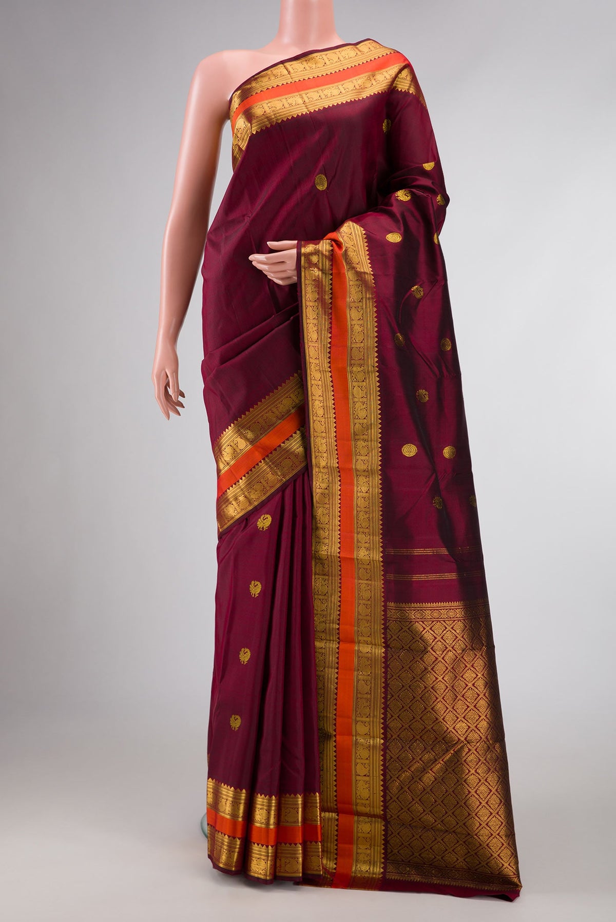 Maroon Dual Tone Kanchipuram Silk Saree with Zari Brocade on the body and Zari Border displayed on a mannequin