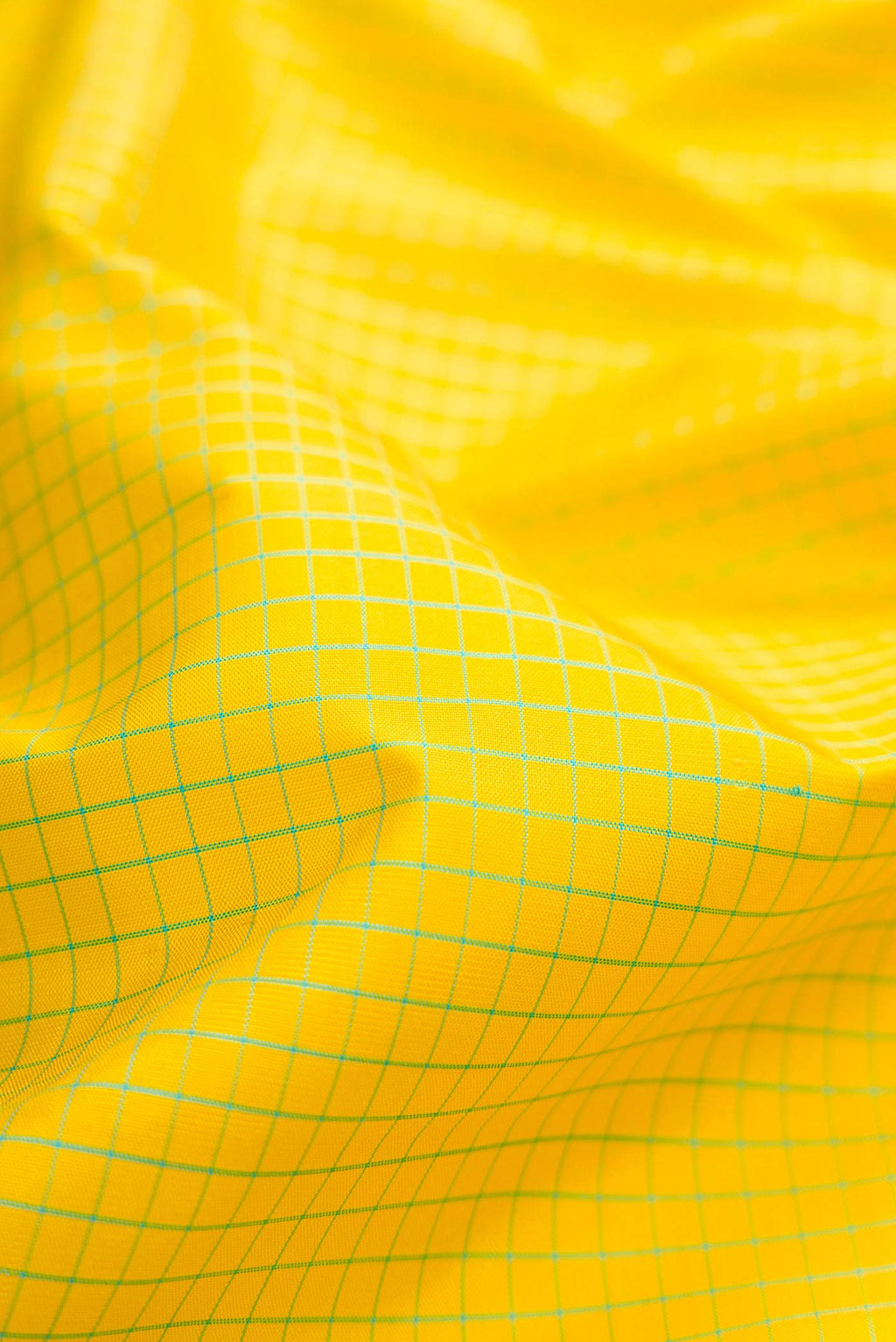 Close up of Lemon Yellow Dual Tone Kanchipuram Silk Saree with Checked design on the body and Zari Border displaying folds