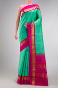 Pure Silk Pure Zari Sea Green Dual Tone Kanjivaram Saree with Plain Body and Zari Border.  displayed on a mannequin
