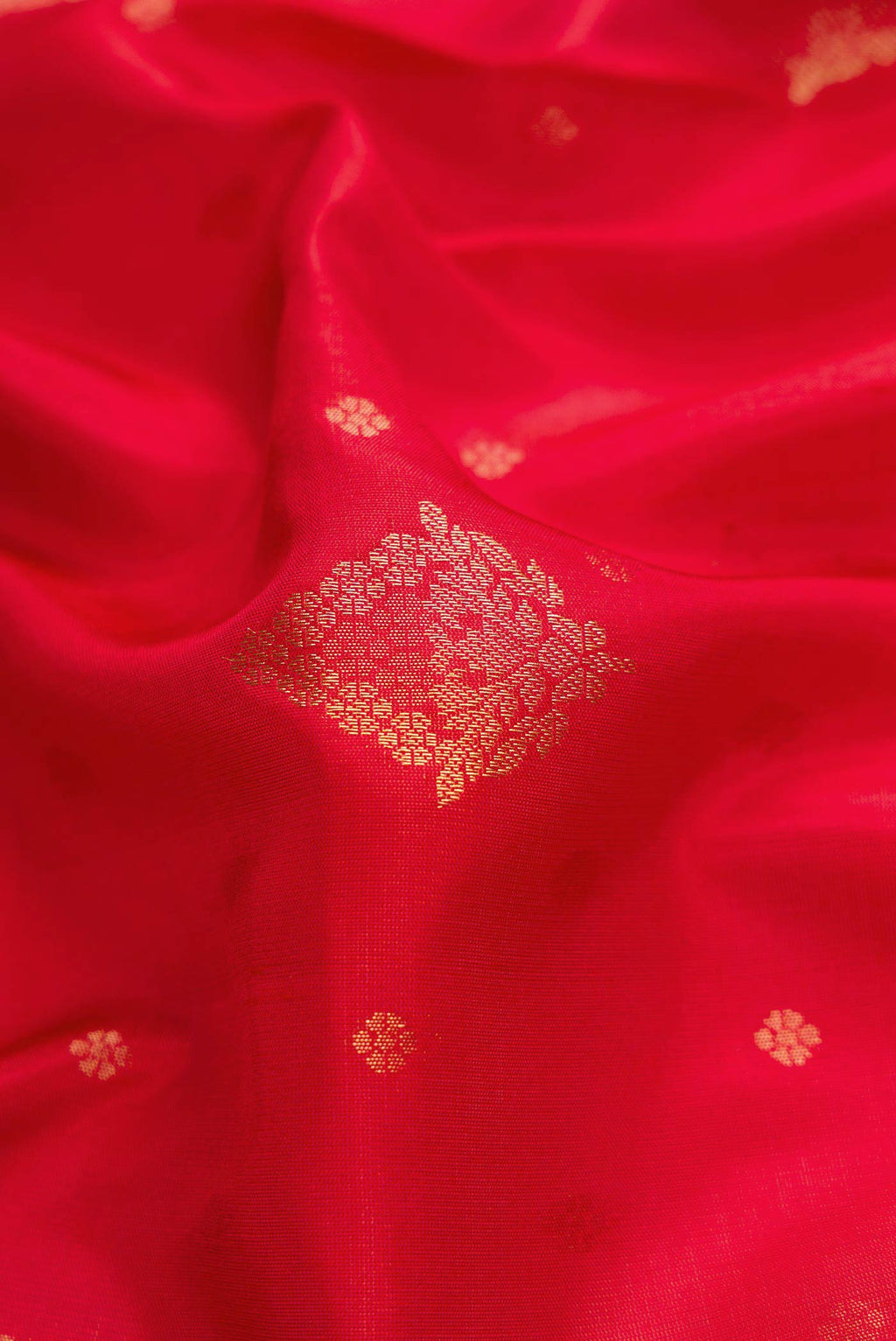 Close up of Red Dual Tone Soft Silk Saree with Zari Butta on the body and Zari Border displaying folds