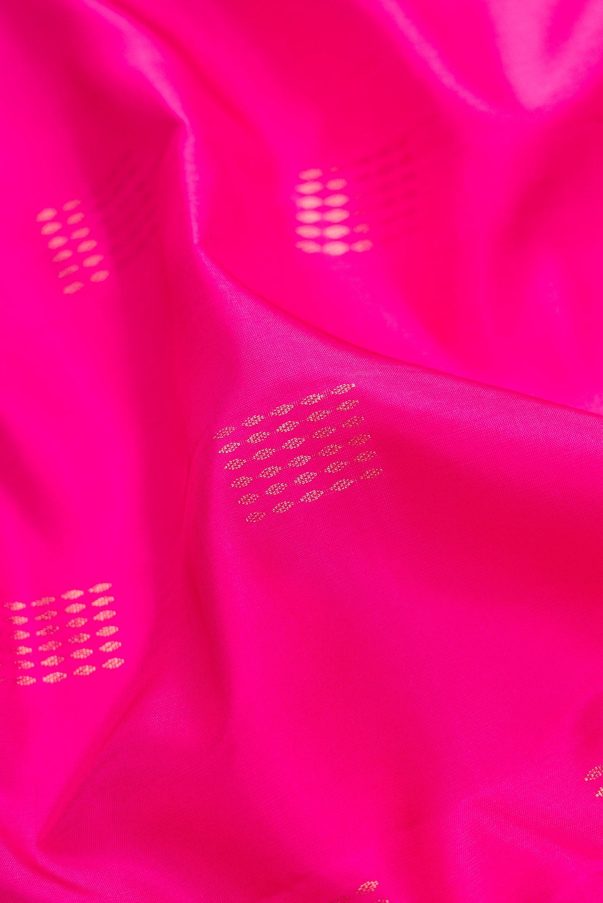 Close up of Pink Dual Tone Soft Silk Saree with Zari Butta on the body and Fancy Border.  displaying folds