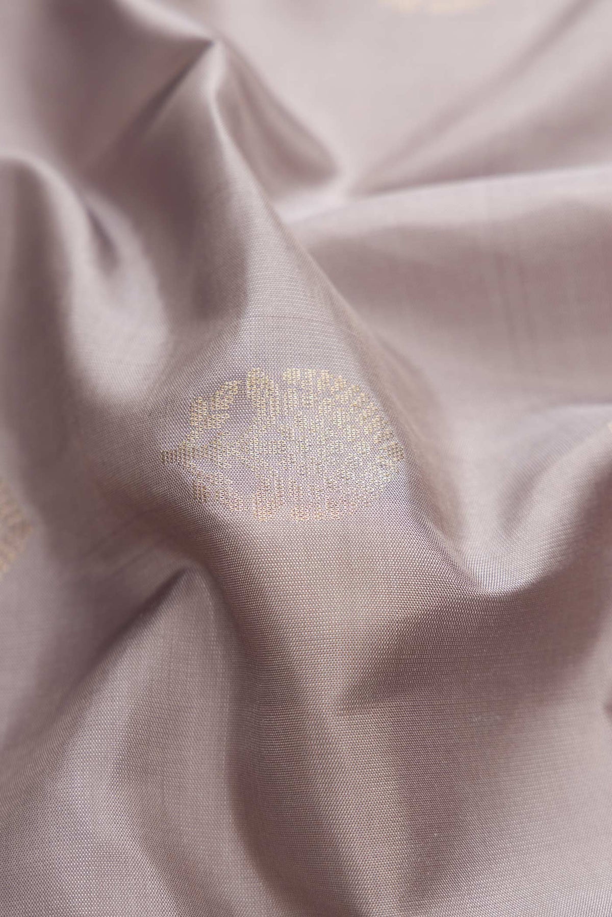 Close up of Grey Dual Tone Soft Silk Saree with Zari Butta on the body and Zari Border displaying folds