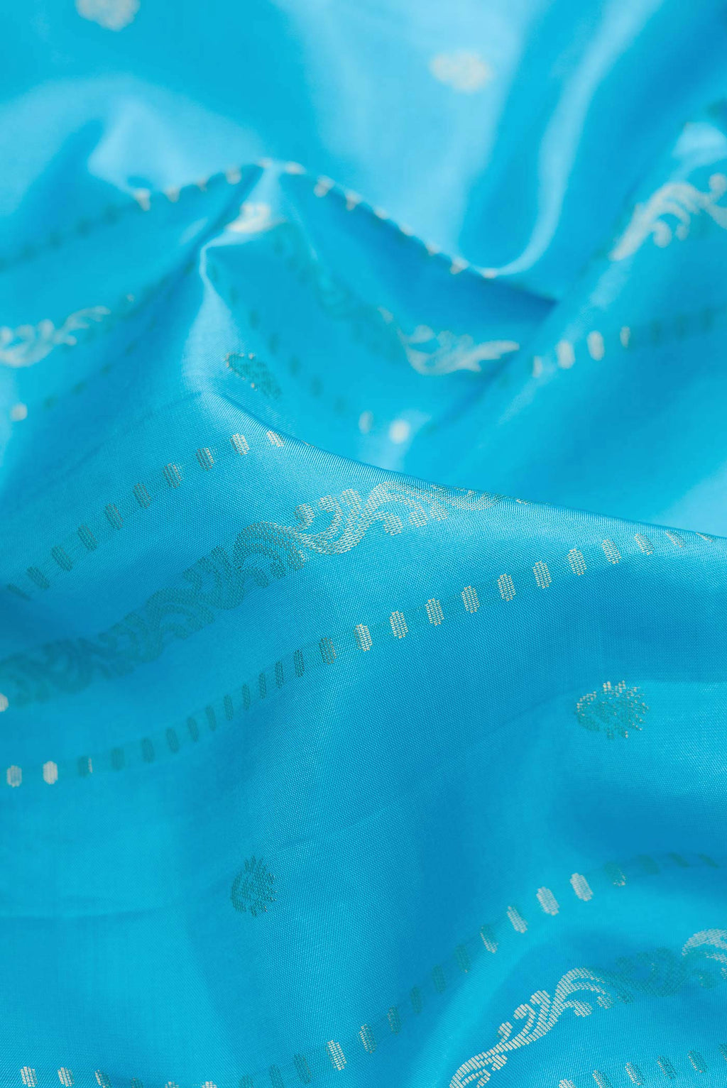 Close up of Sky Blue Dual Tone Soft Silk Saree with Stripes on the body and Zari Border.  displaying folds