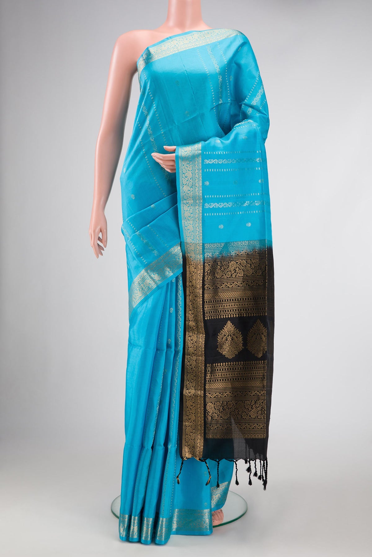 Sky Blue Dual Tone Soft Silk Saree with Stripes on the body and Zari Border.  displayed on a mannequin