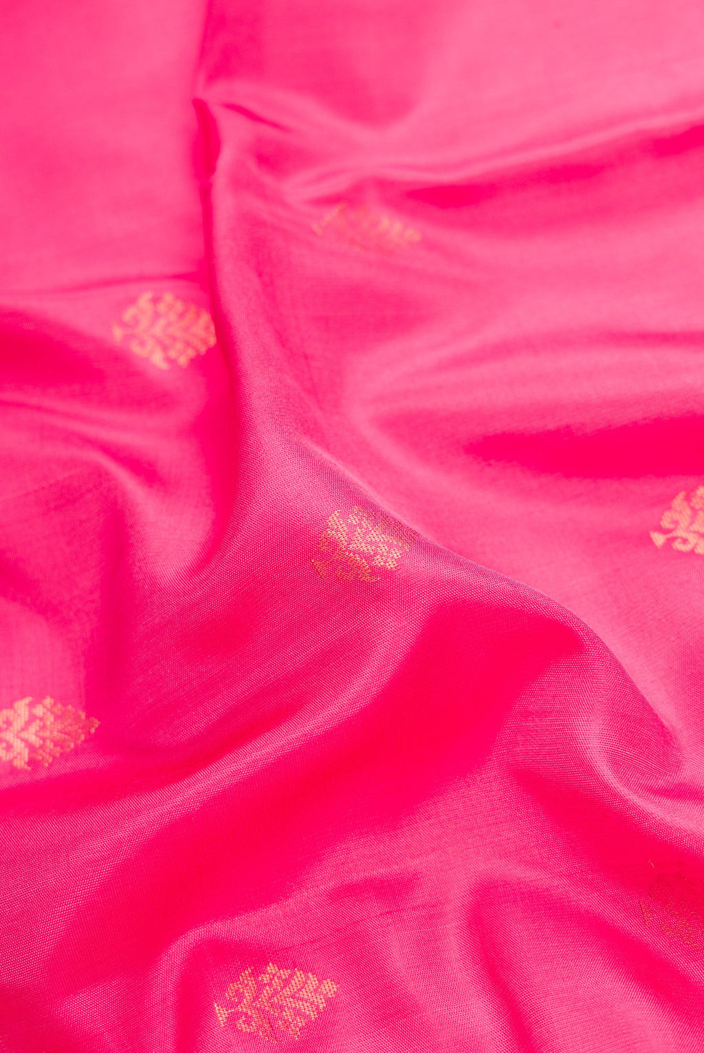 Close up of Pink Dual Tone Soft Silk Saree with Zari Butta on the body and Zari Border.  displaying folds