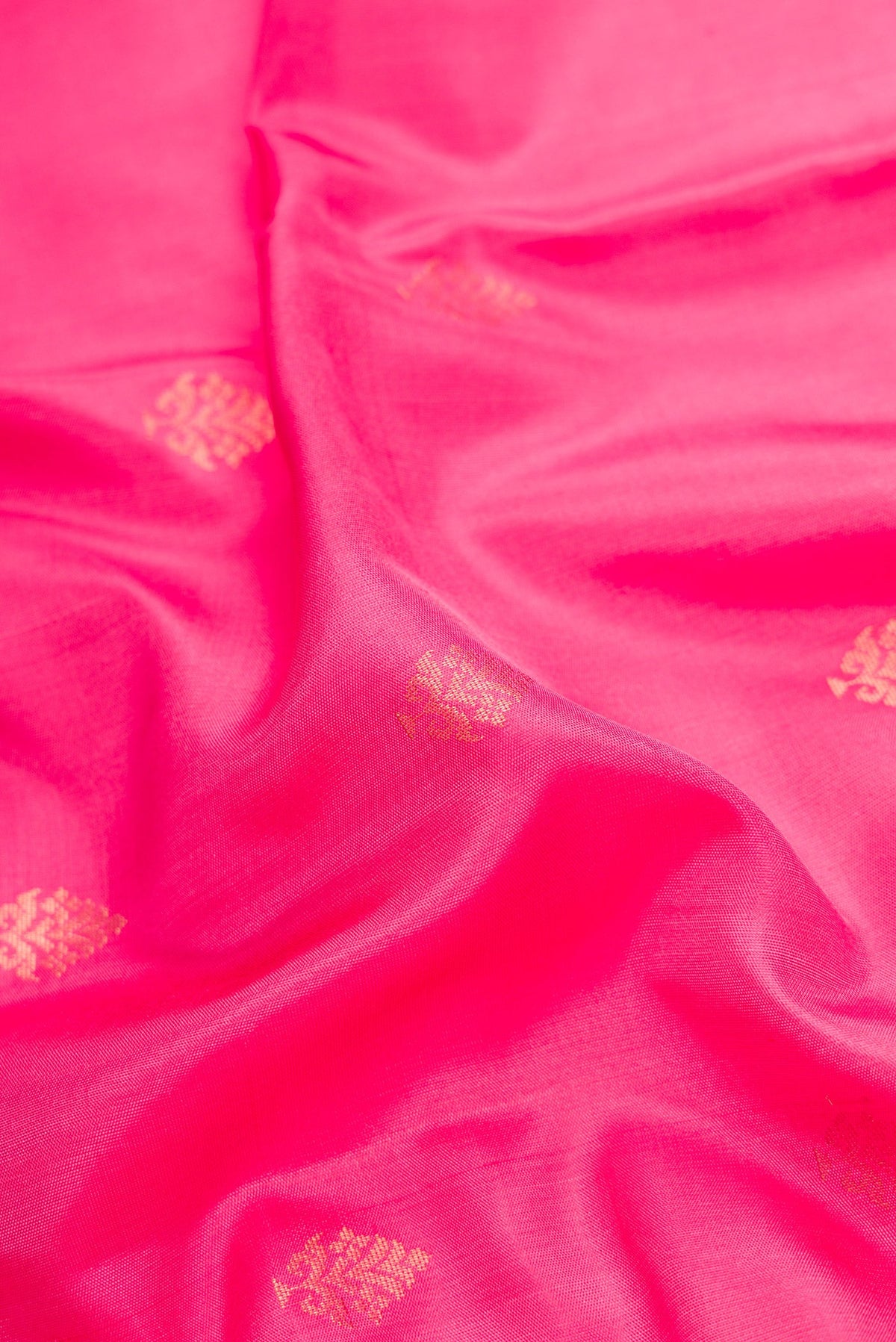 Close up of Pink Dual Tone Soft Silk Saree with Zari Butta on the body and Zari Border.  displaying folds