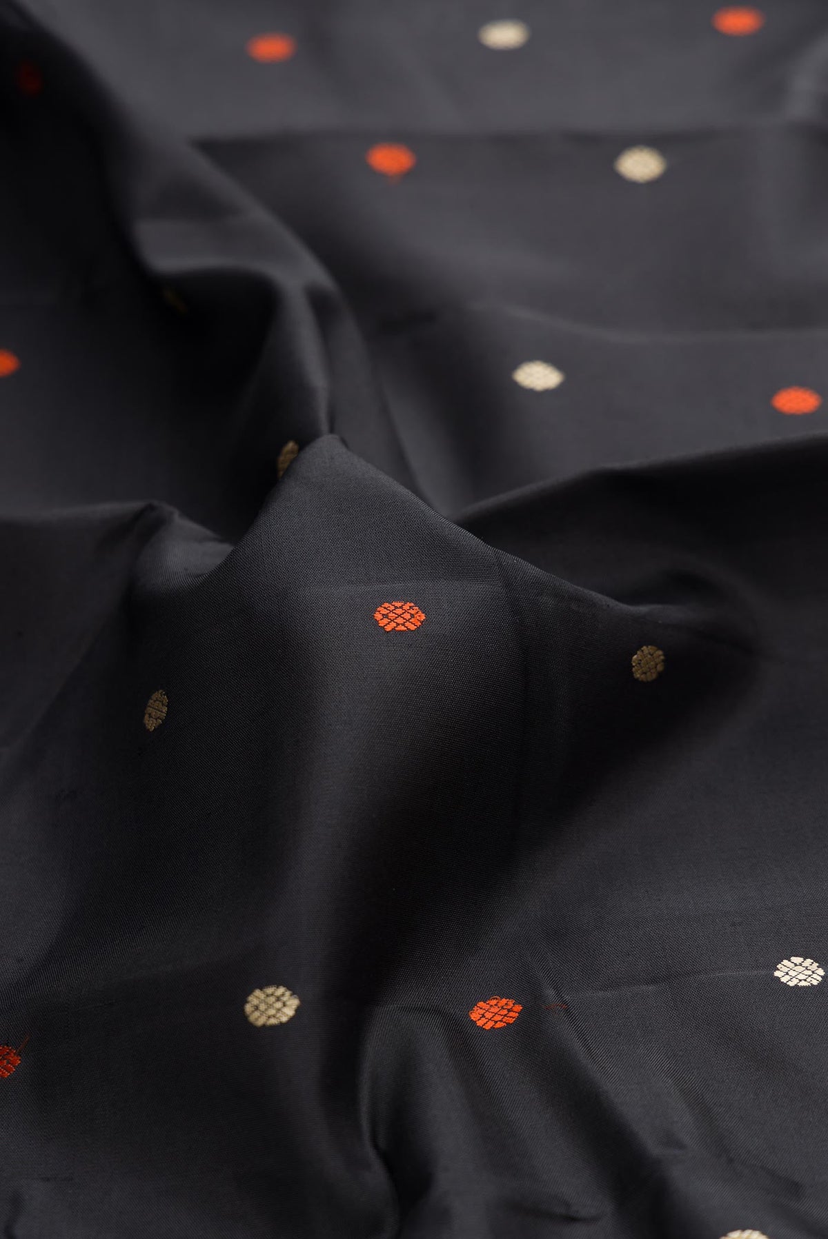 Close up of Black Dual Tone Kanchipuram Silk Saree with Thread Butta on the body and Thread Border displaying folds