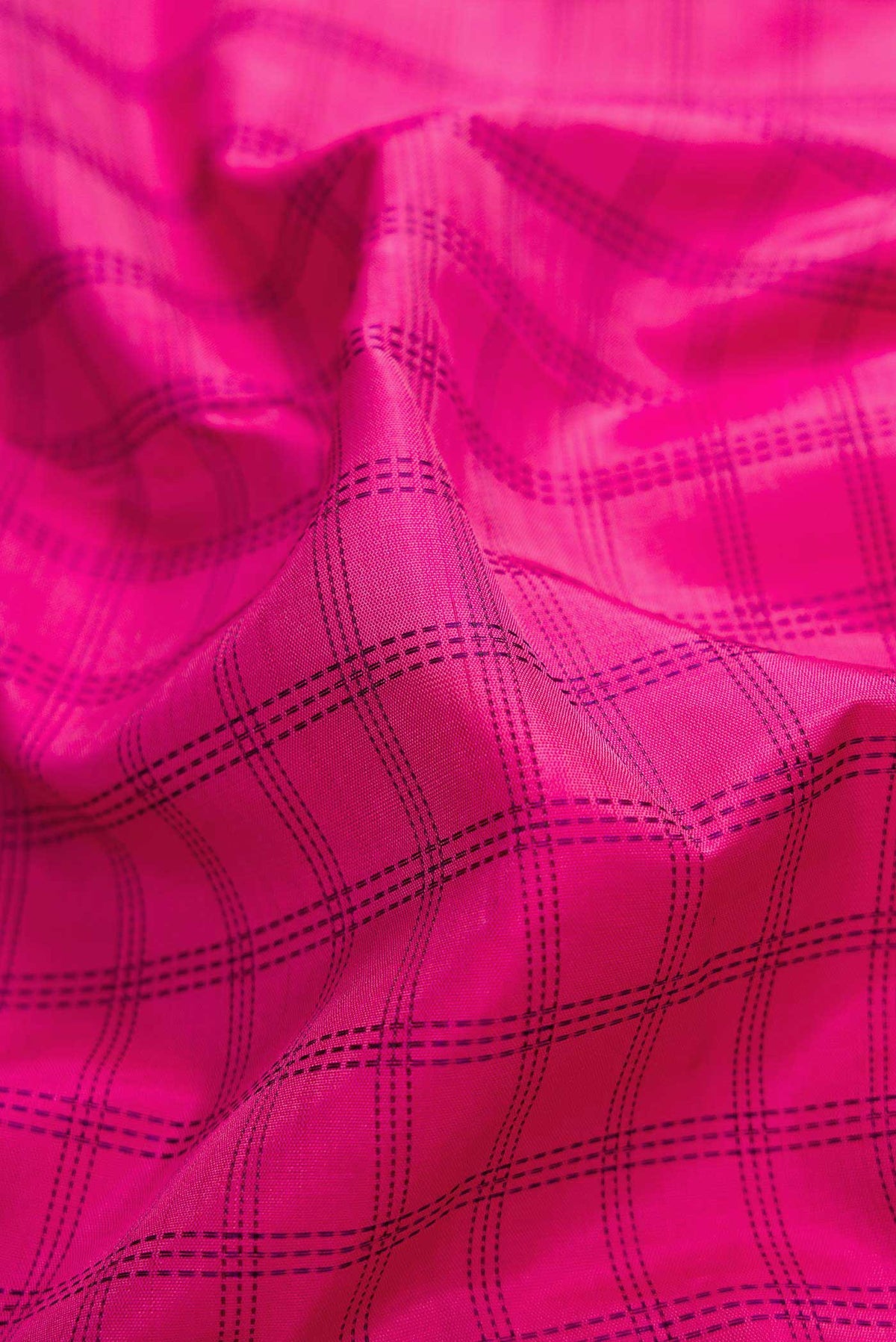 Close up of Pure Silk Pure Zari Pink Dual Tone Kanchipuram Saree with Checked design on the body and Zari Border displaying folds
