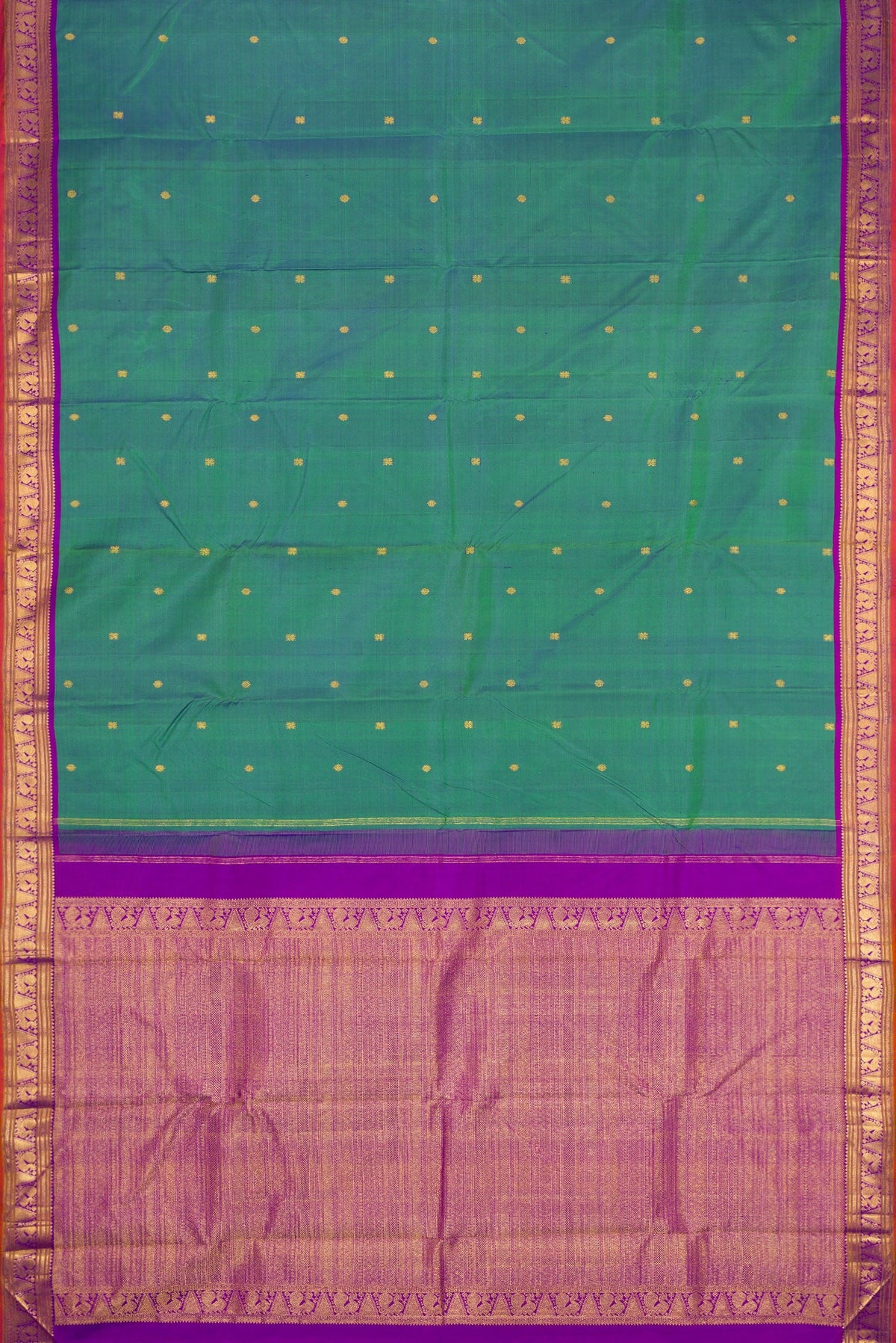 Flat view of Peacock Blue Dual Tone Kanchipuram Silk Saree with Zari Butta on the body and Zari Border. 