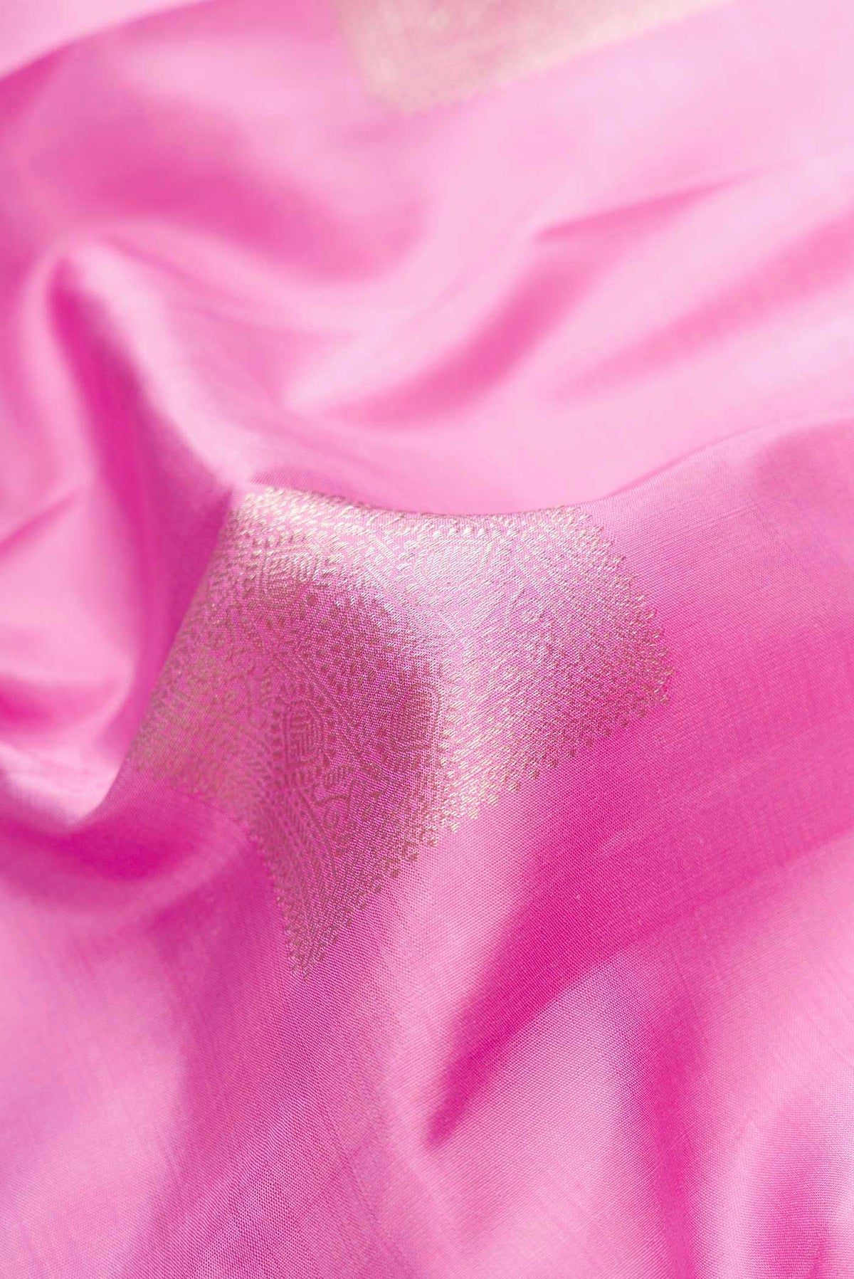 Close up of Pink Dual Tone Kanjivaram Silk Saree with Zari Butta on the body and Fancy Border.  displaying folds