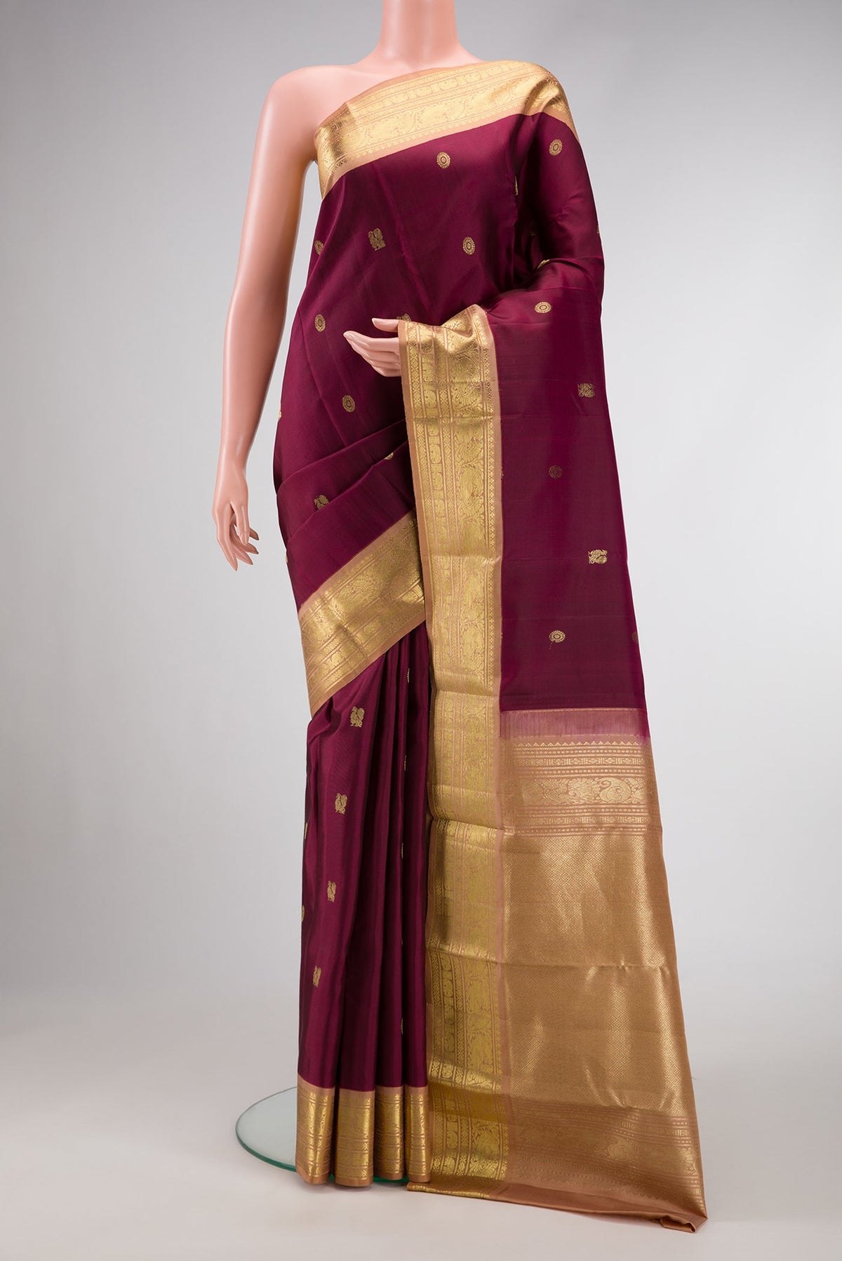 Coffee Brown Dual Tone Kanjivaram Silk Saree with Zari Butta on the body and Zari Border.  displayed on a mannequin