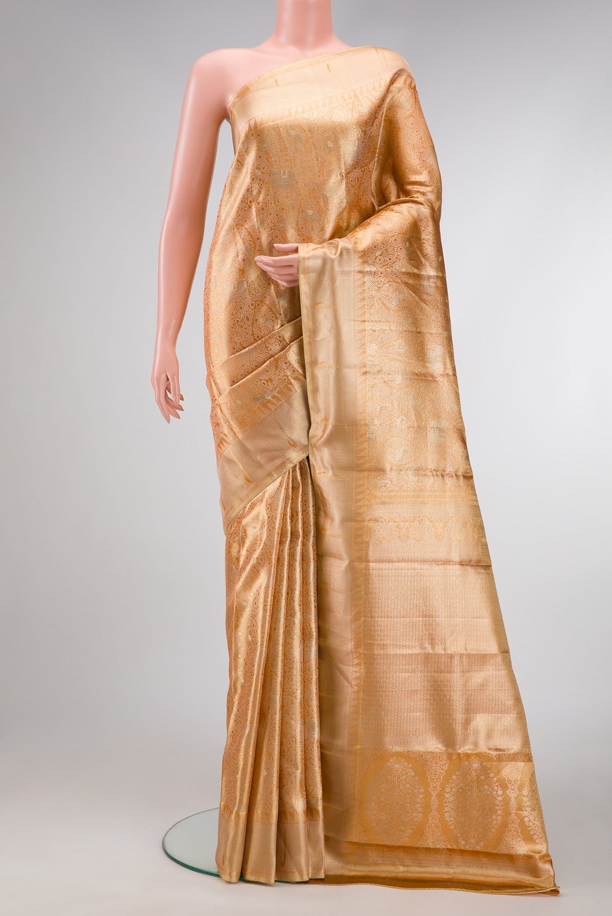 Golden Peach Dual Tone Kanjivaram Tissue Silk Saree with Zari Brocade on the body and Zari Border.  displayed on a mannequin