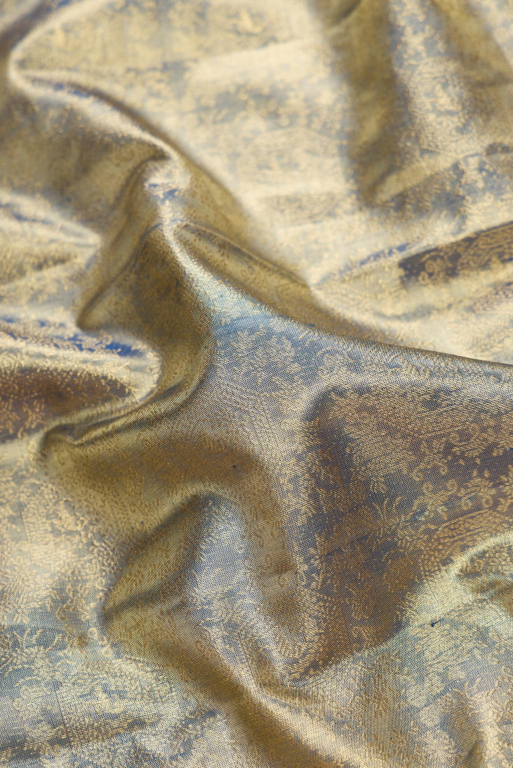 Close up of Green Dual Tone Kanjivaram Tissue Silk Saree with Zari Brocade on the body and Zari Border.  displaying folds