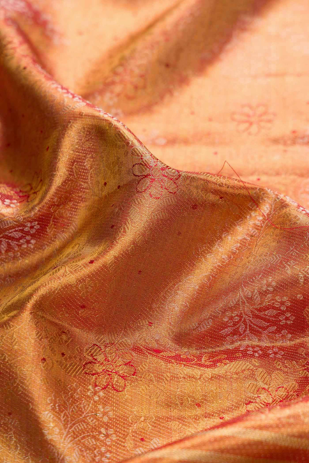 Close up of Gold Dual Tone Kanchipuram Silk Saree with Zari Brocade on the body and Zari And Thread Border displaying folds