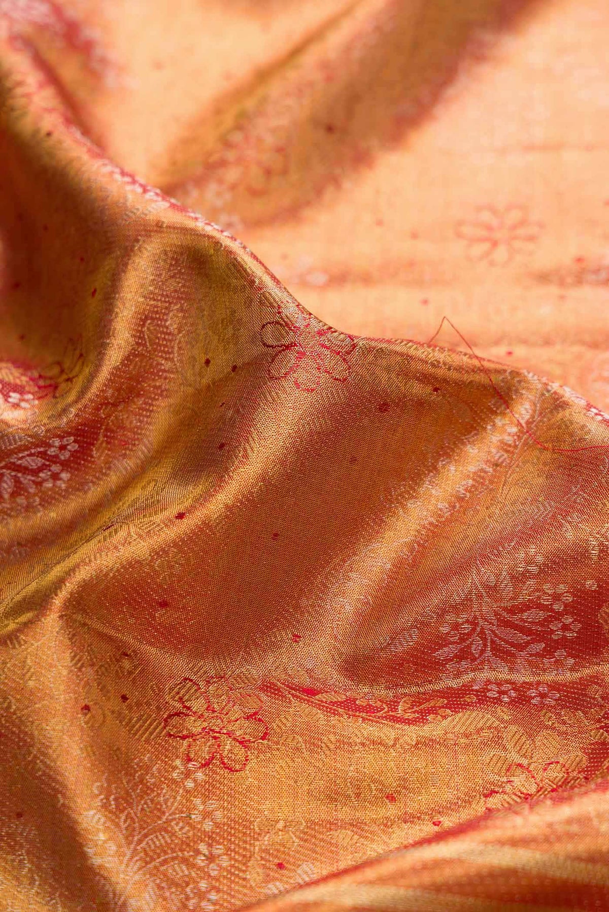 Close up of Gold Dual Tone Kanchipuram Silk Saree with Zari Brocade on the body and Zari And Thread Border displaying folds