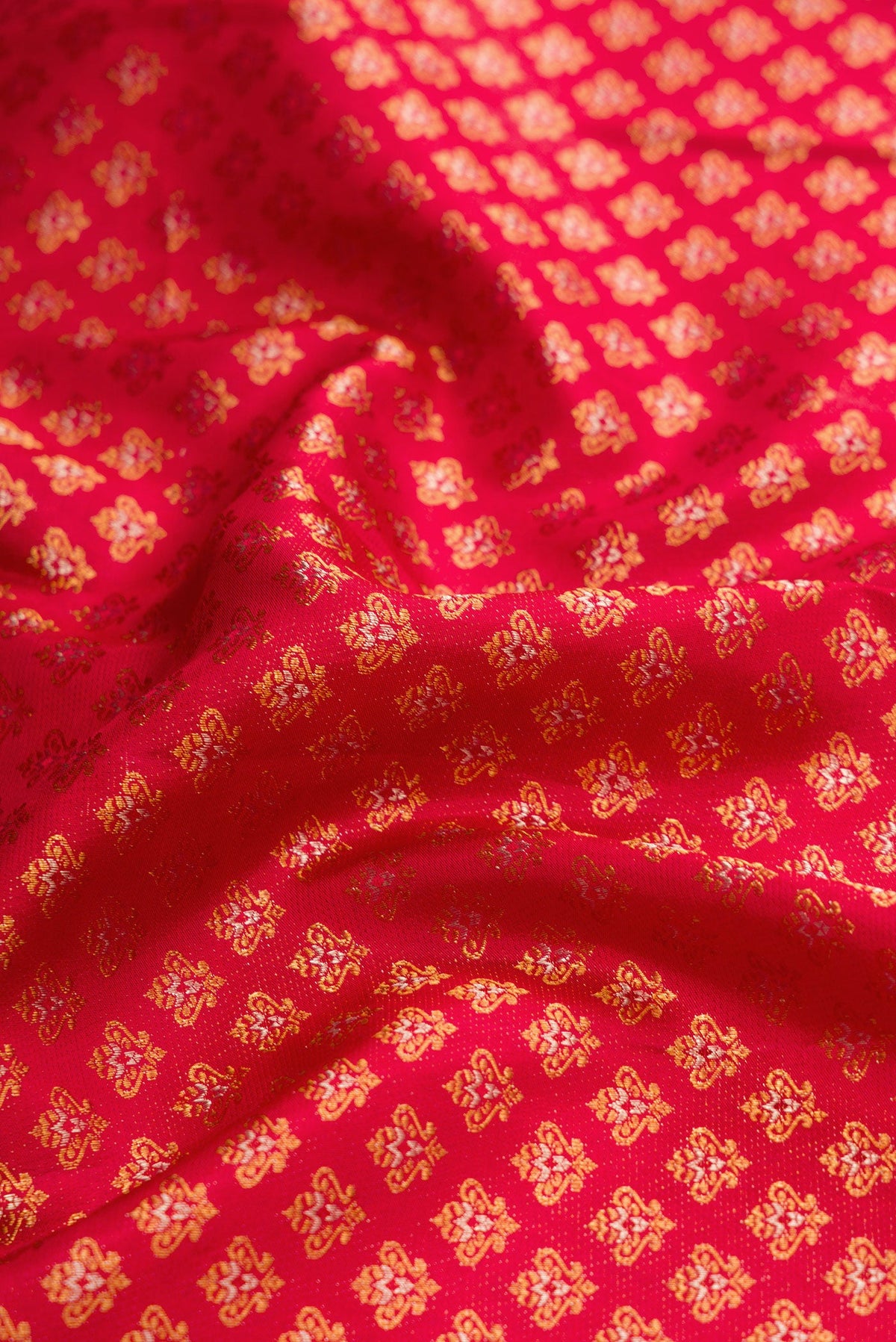 Close up of Red Dual Tone Kanjivaram Silk Saree with Zari Brocade on the body and Fancy Border.  displaying folds