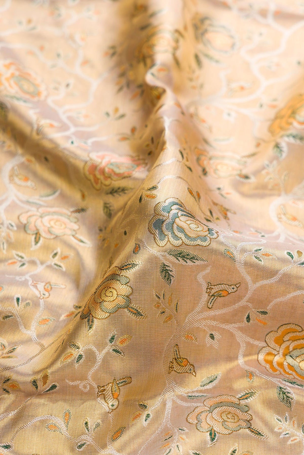Close up of Gold Dual Tone Kanchipuram Tissue Silk Saree with Zari Brocade on the body and Zari Border.  displaying folds