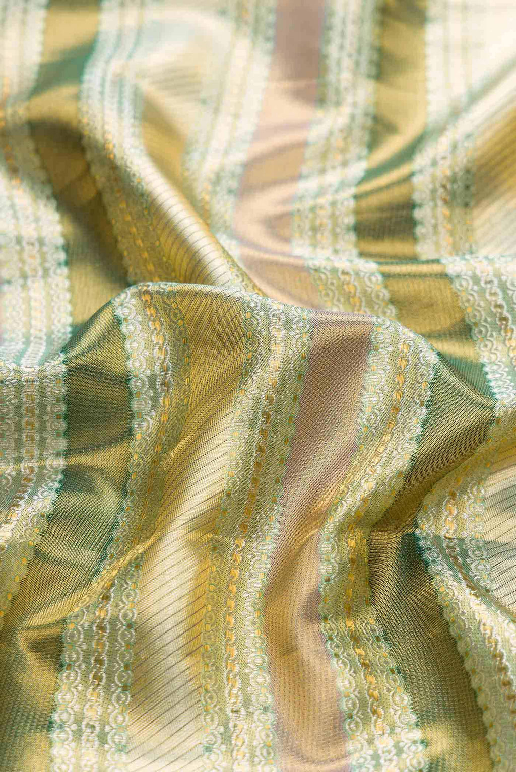 Close up of Green Dual Tone Kanchipuram Tissue Silk Saree with Zari Brocade on the body and Zari Border displaying folds