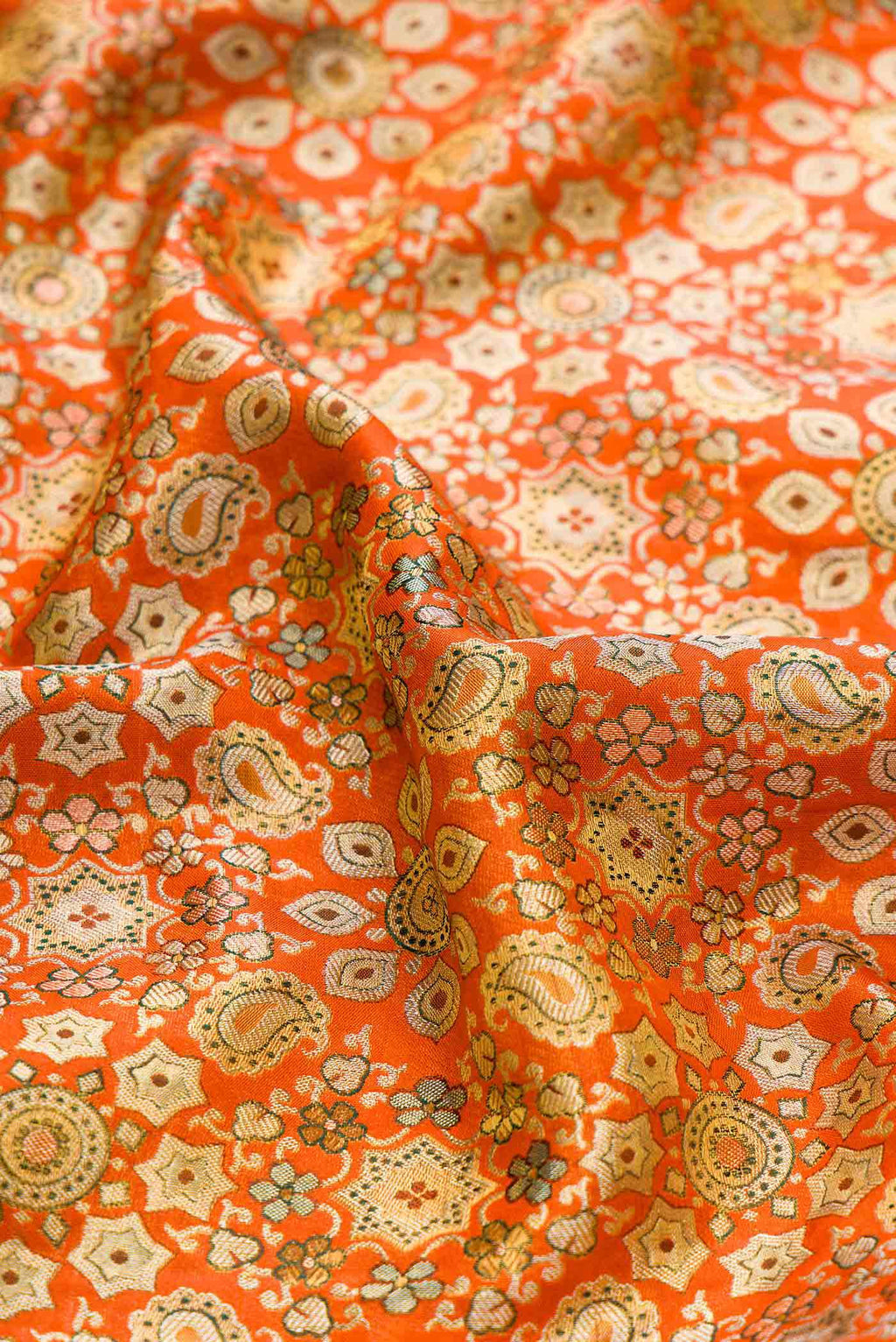 Close up of Orange Dual Tone Kanchipuram Tissue Silk Saree with Zari Brocade on the body and Zari Border displaying folds