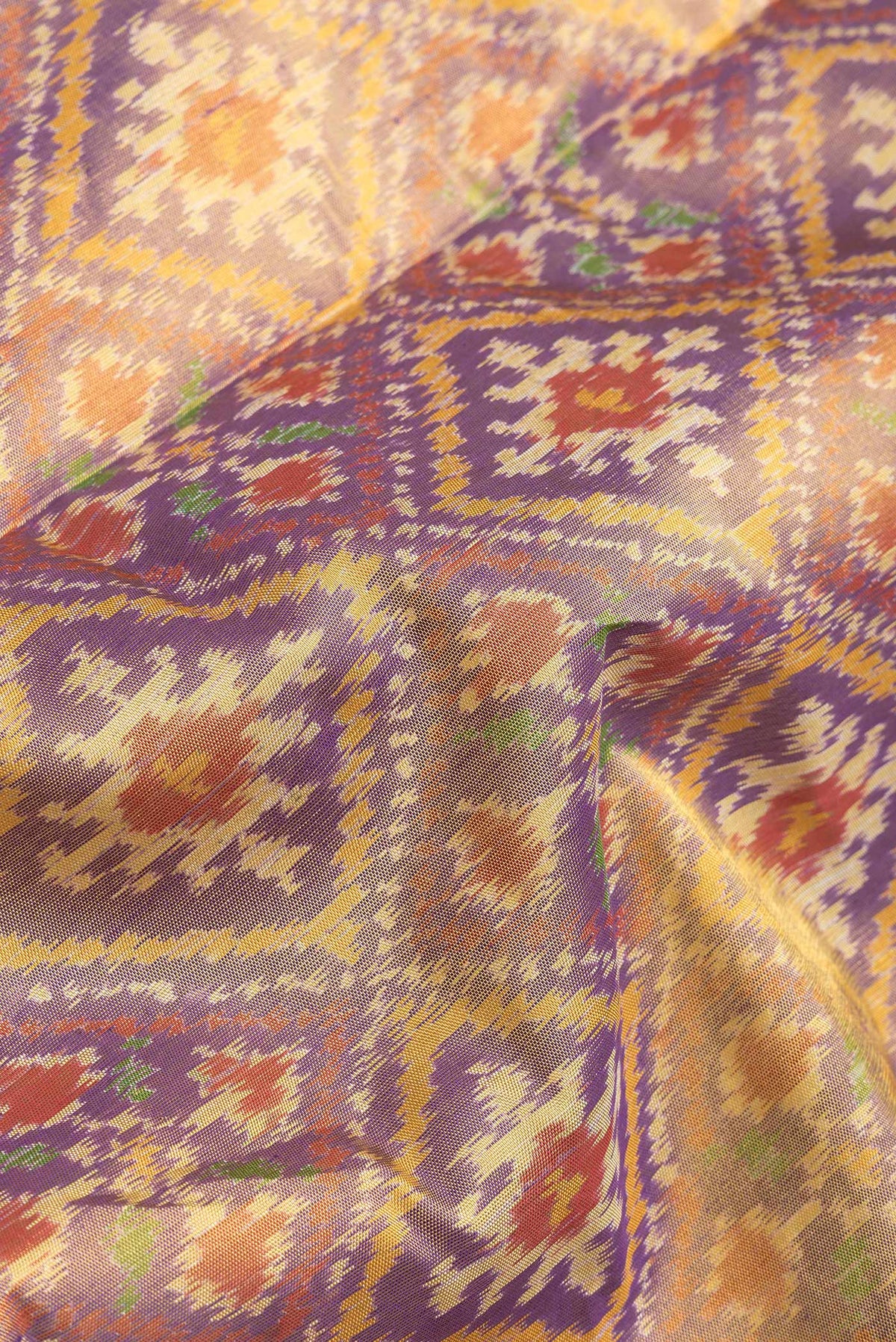 Close up of Lavender Dual Tone Double Ikat Saree with Ikat Print on the body and Zari Border.  displaying folds