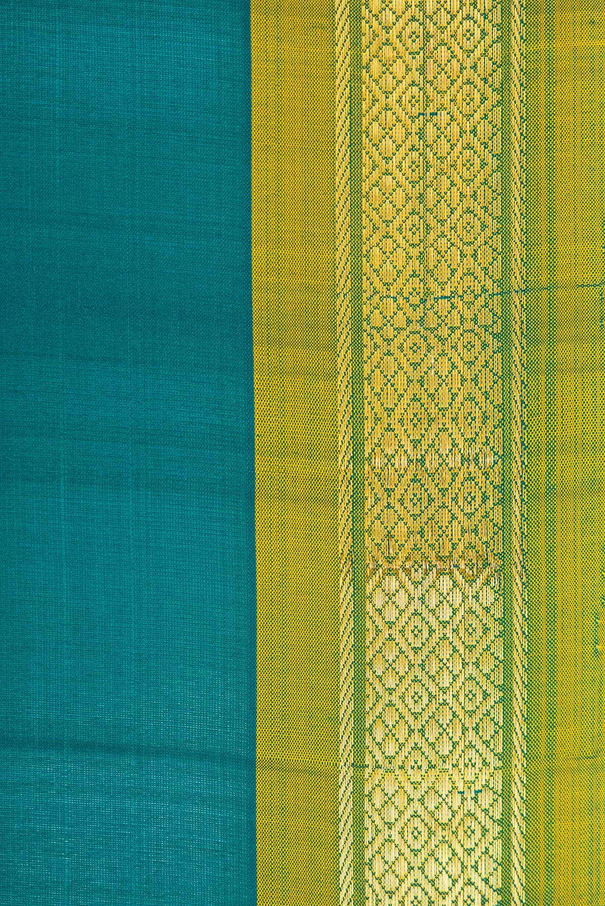 Border image of Peacock Blue Dual Tone Kanchipuram Silk Saree with Plain Body and Zari Border. 