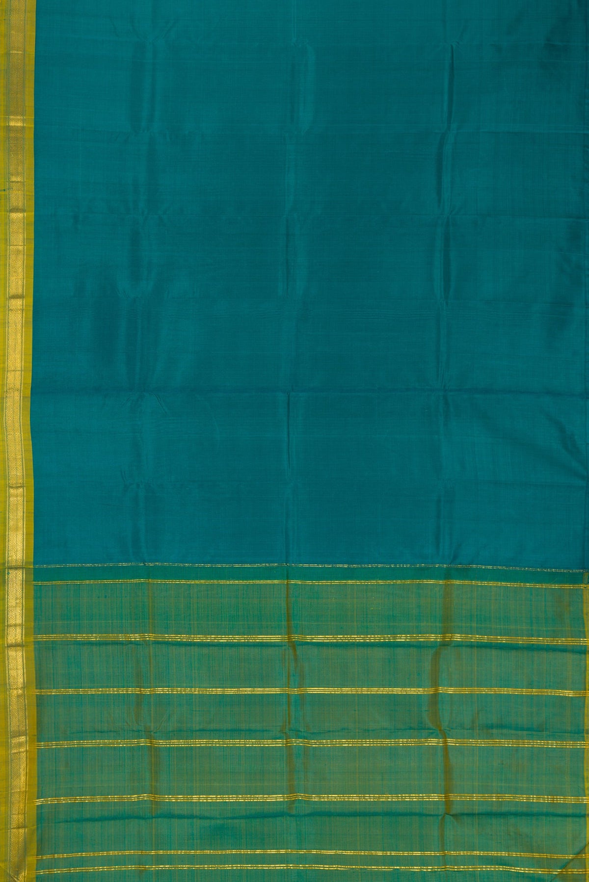 Peacock Blue Dual Tone Kanchipuram Silk Saree with Plain Body and Zari Border.  displayed on a mannequin